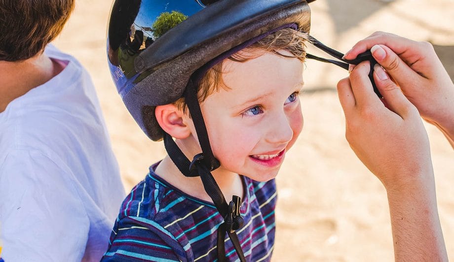 Camper getting help with his helmet