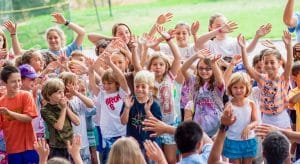 Campers with their hands in the air