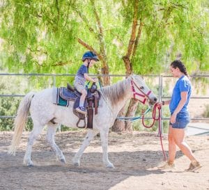 Camper riding a horse