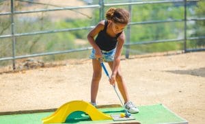 Camper playing mini golf