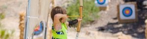 Camper doing an archery shot