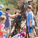 Campers build a tepee