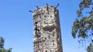 Camper climbing the rock climbing wall