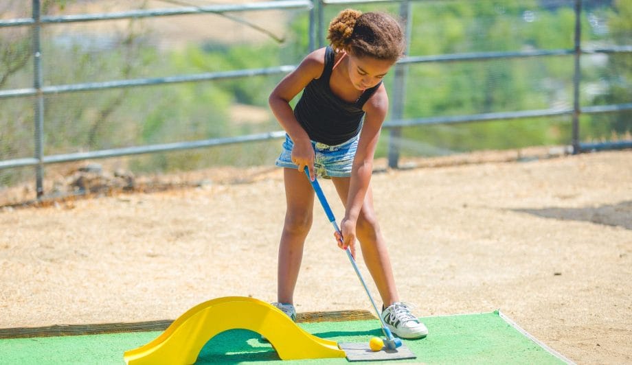 Camper playing mini golf