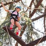 a girl rapelling on a ropes course