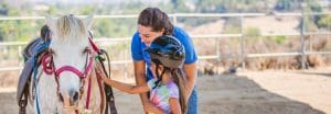 Camper petting a horse