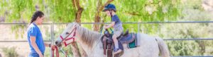 Camper riding a horse