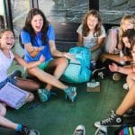 Girls playing a hand game in a circle