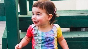 Toddler in Camp Kinneret Tie Dye Onsie