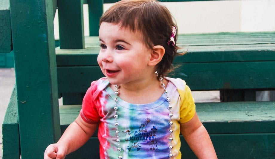 Toddler in Camp Kinneret Tie Dye Onsie