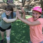 Two campers give double high fives