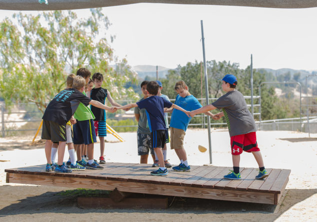 Campers balancing on balance board