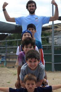 A counselor imitating a totem pole with campers