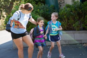 A counselor walks with two calmpers