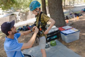 Camper getting ready for high ropes