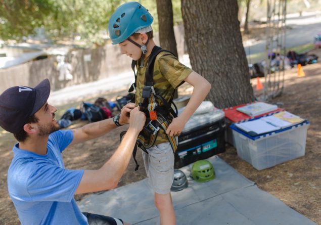 Camper getting ready for high ropes