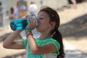 Camper drinking out of her water bottle